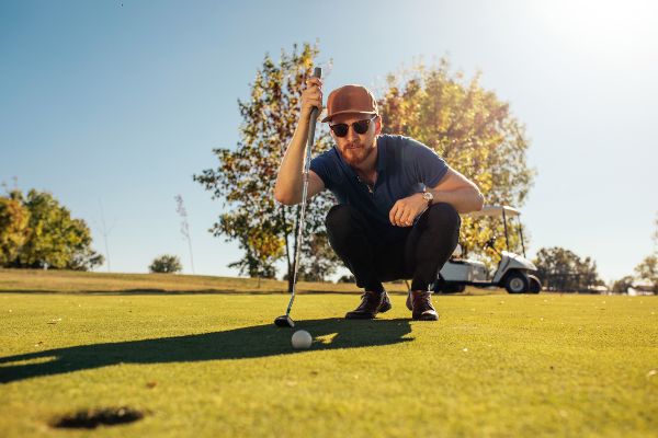 A player with his colored golf lenses focusing on the ball