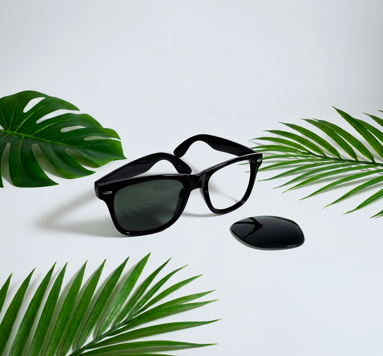 Black Wayfarer sunglasses showing the removal of an old lens for a premium replacement